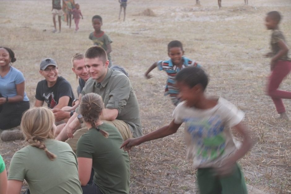 cadet plays with children in Botswana