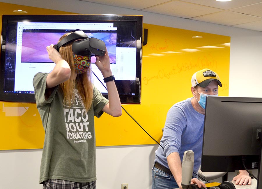 A student uses VR goggles.