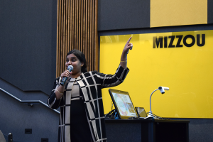 Kiruba Krishnaswamy presenting in Ketcham Auditorium.