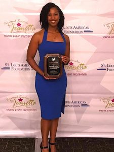 Janae Bradley holding the Dr. Donald M. Suggs Dissertation Support Fellowship plaque.