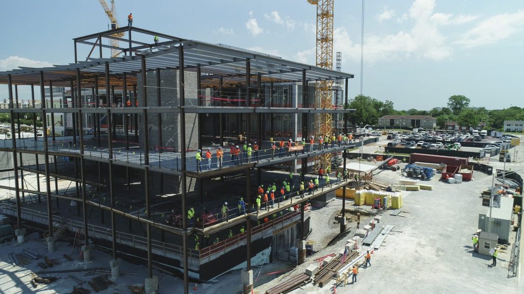 Placement of final steel beam on NextGen Health Institute building