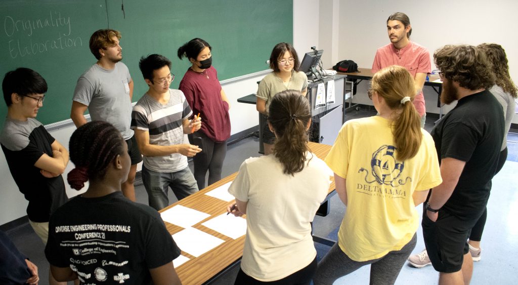 Group of students around table.