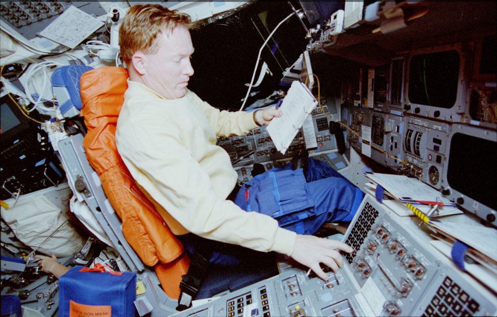 Dick Richards photographed in the Space Shuttle Discovery.