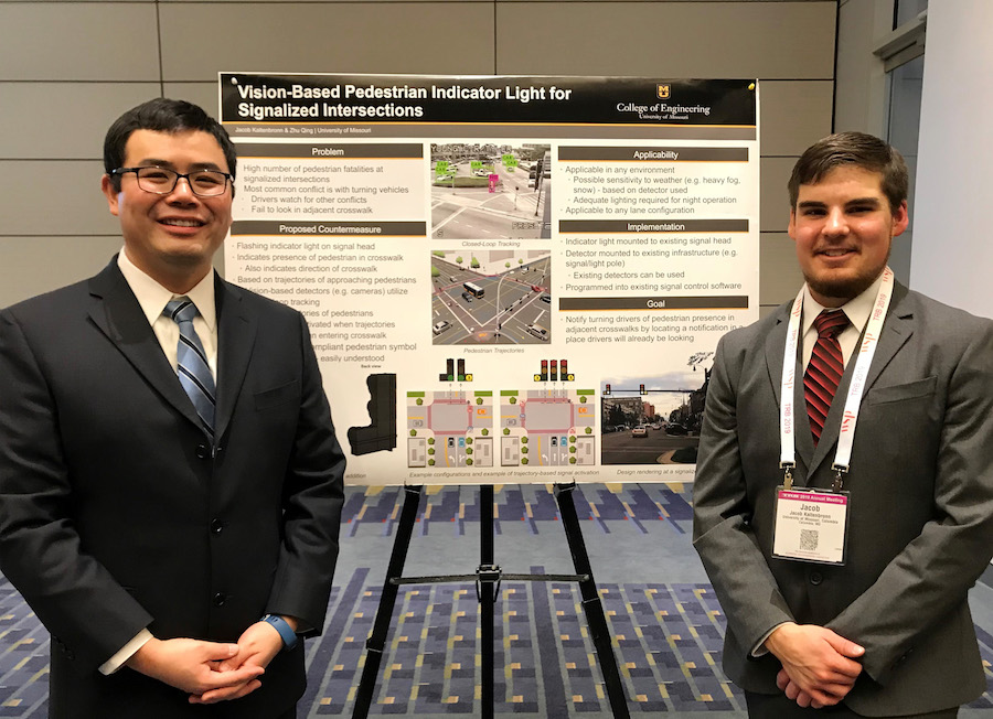 Zhu Qing and Jacob Kaltenbronn in front of a research poster for Vision-Based Pedestrian Indicator Light for Signalized Intersections