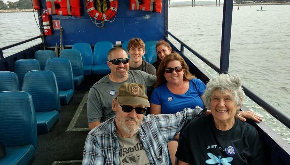 A family rides on a duck boat.