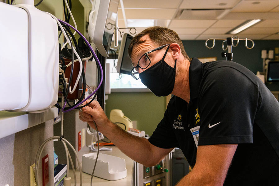 Man working with device.