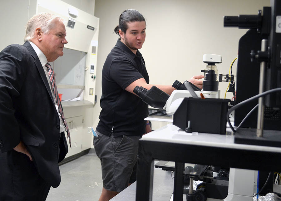 O'Neill and Boyle at equipment in lab.