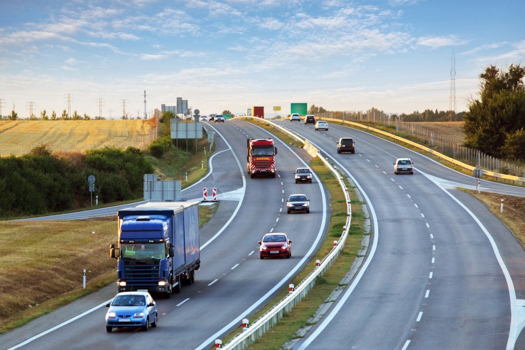 Highway,Traffic,In,Sunset,With,Cars,And,Trucks